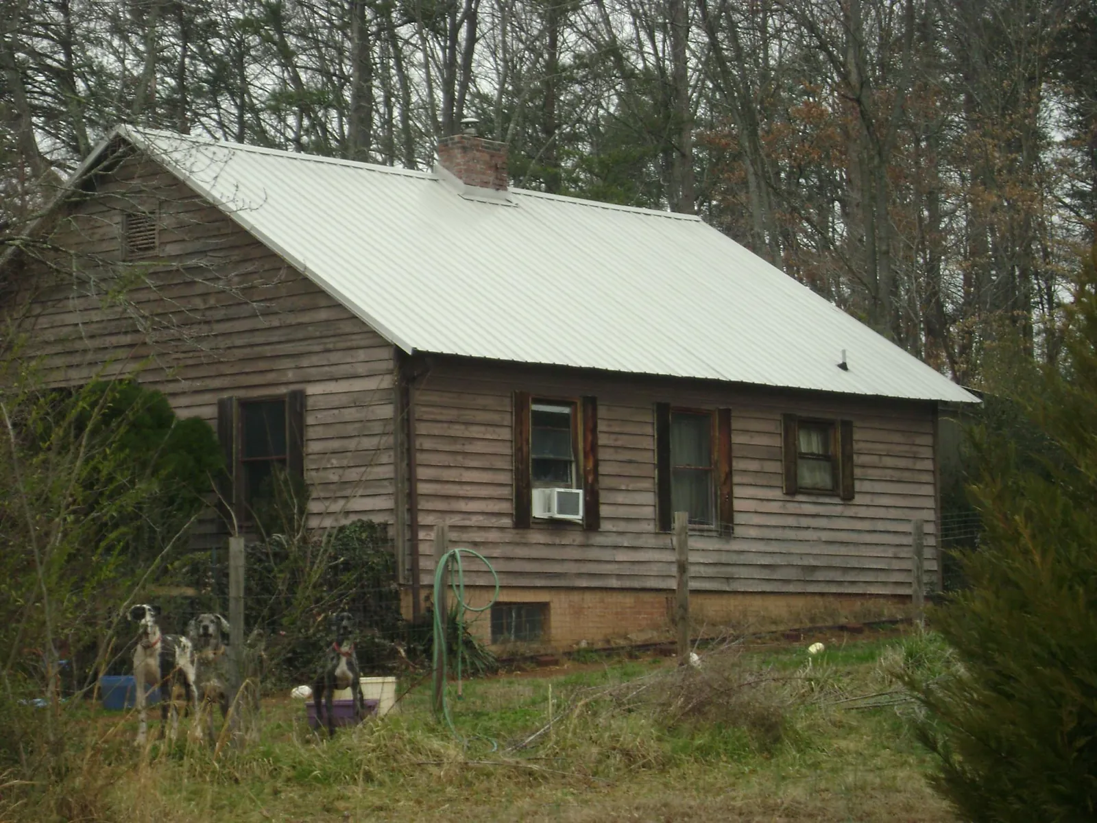 White metal roof on an old wood sided farmhouse, from a Metal Roof Installation job in Osceola Mills